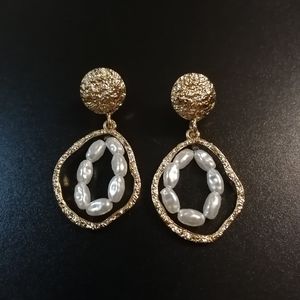 Golden earrings with white stones